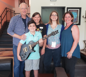 PRS Guitars founder and Managing General Partner Paul Reed Smith (left) presents a new PRS guitar to lucky Summer Reading Program winner Zander Smith (10) of Stevensville, accompanied by (left to right) Queen Anne’s County Library youth service coordinator Julie Ranelli, Kent Island Youth Services Librarian Elaine Conway, and president of the Friends of Queen Anne’s County Library Kathie Smarick