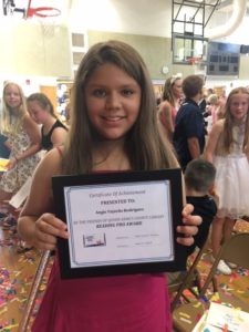 Matapeake Elementary School Reading Pro Angie Fajardo Rodriguez displays her award during the school’s promotion ceremony